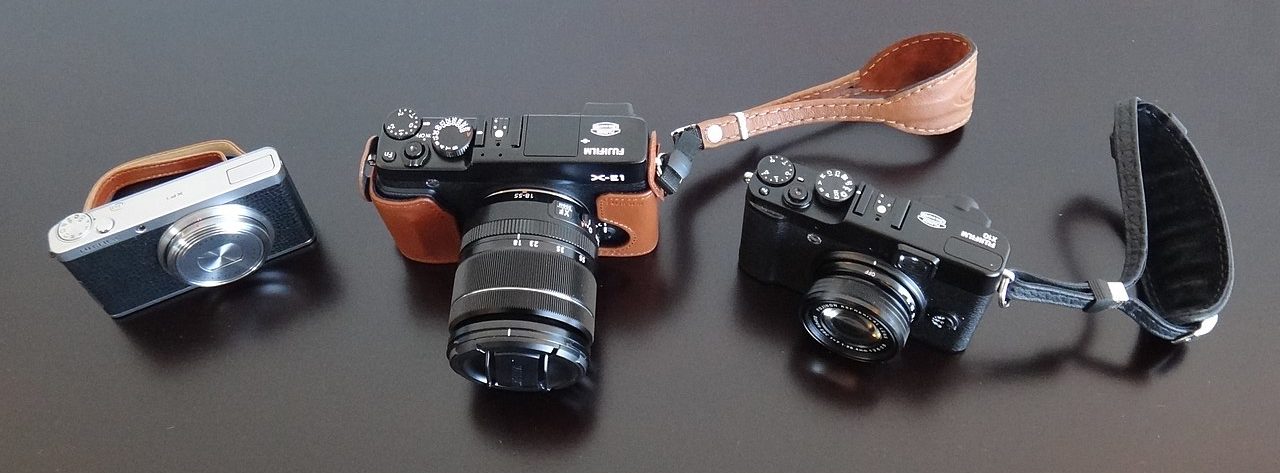 Three different cameras on a table